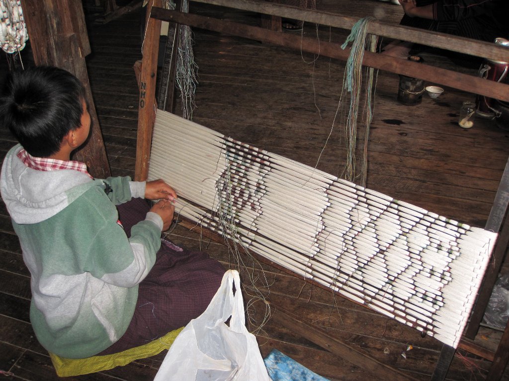 50-The weaving process, the pattern is created with multi colored threads.jpg -                                